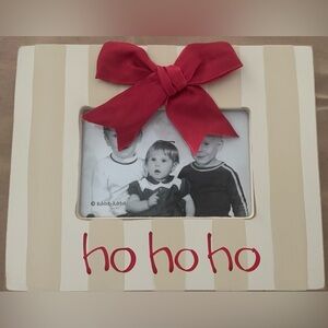Ho ho ho wooden picture frame with red bow and wooden dowel. New in package.